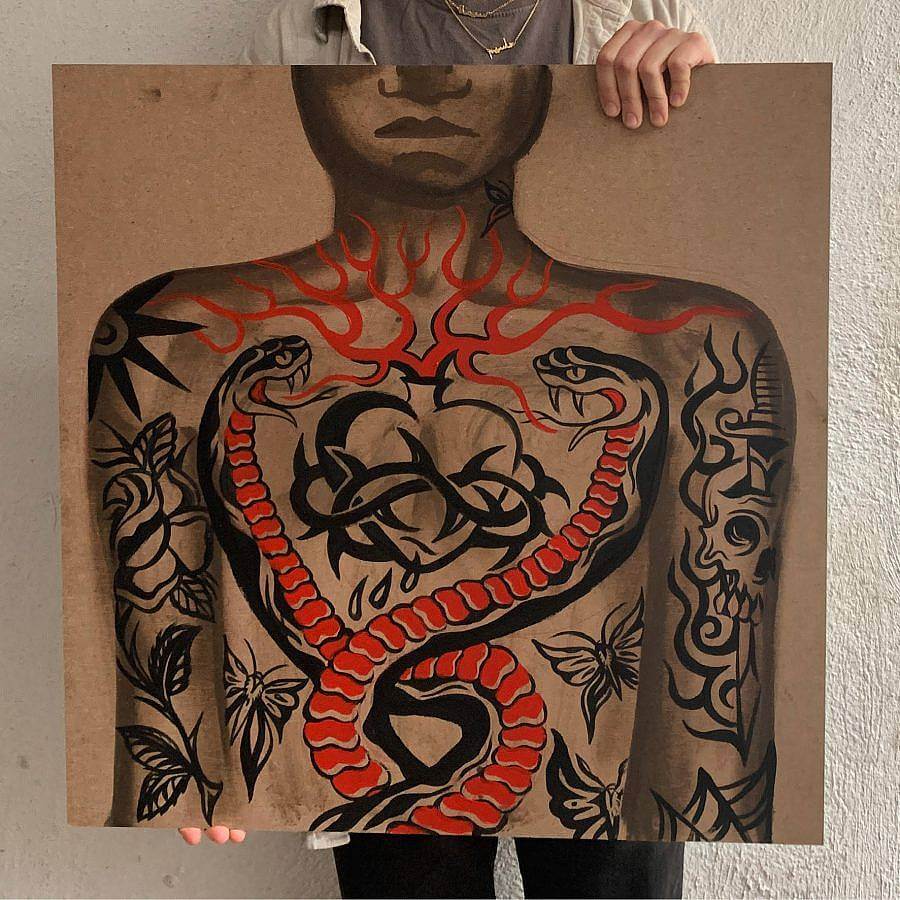 A person holds up a painting. The painting uses latex paint on masonite. It features a tattooed person. The chest has a heart tattooed on it, with thorns encircling it, red flame line work extends outside it. Two snakes encircle the heart. Other tattoos of skulls and butterflies are on the person's arms.